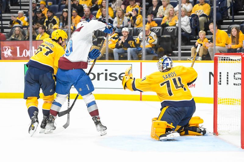 Nov 20, 2023; Nashville, Tennessee, USA;  Nashville Predators goaltender Juuse Saros (74) bloc=ks the deflection of Colorado Avalanche center Ross Colton (20) during the second period at Bridgestone Arena. Mandatory Credit: Steve Roberts-USA TODAY Sports