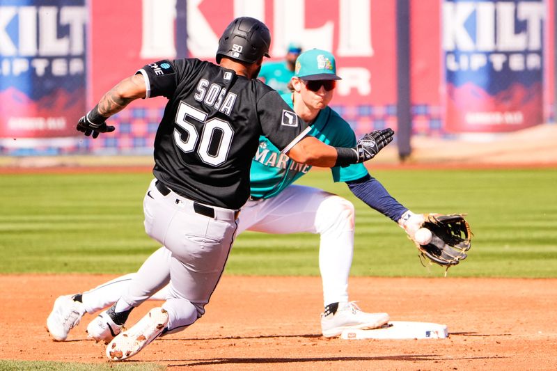 Feb 24, 2026; Peoria, Arizona, USA;  Seattle Mariners shortstop Colt Emerson (85) prepares to tag out Chicago White Sox second baseman Lenyn Sosa (50) at second base during the third inning in Peoria, Arizona. Mandatory Credit: Arianna Grainey-Imagn Images