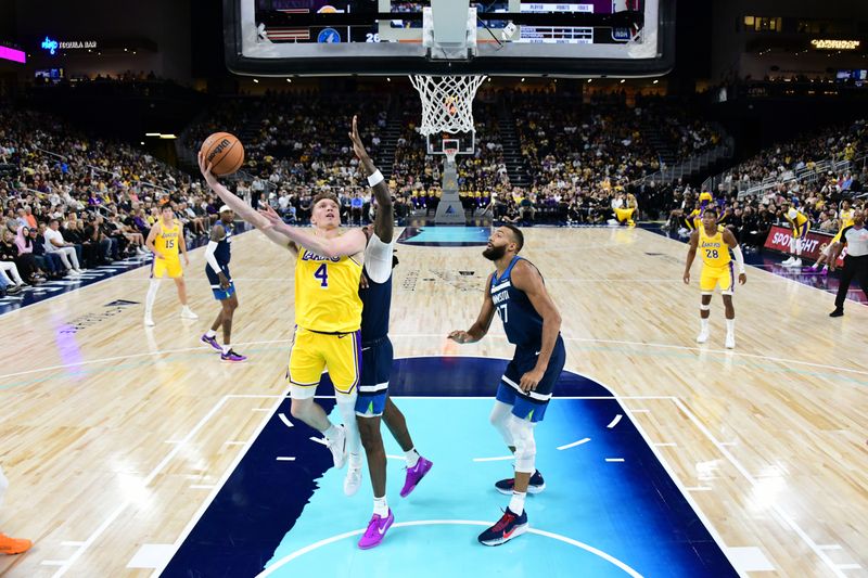 PALM SPRINGS, CA - OCTOBER 4: Dalton Knecht #4 of the Los Angeles Lakers drives to the basket during the game against the Minnesota Timberwolves during an NBA preseason game on October 4, 2024 at Acrisure Arena in Palm Springs, California. NOTE TO USER: User expressly acknowledges and agrees that, by downloading and/or using this Photograph, user is consenting to the terms and conditions of the Getty Images License Agreement. Mandatory Copyright Notice: Copyright 2024 NBAE (Photo by Adam Pantozzi/NBAE via Getty Images)