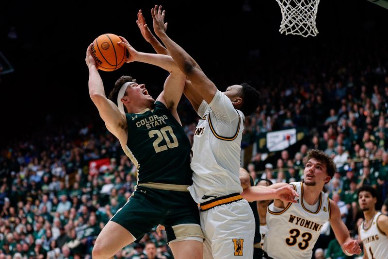 Mar 2, 2024; Fort Collins, Colorado, USA; Colorado State Rams guard Joe Palmer (20) attempts a shot as Wyoming Cowboys forward Cam Manyawu (5) defends in the first half at Moby Arena. Mandatory Credit: Isaiah J. Downing-USA TODAY Sports