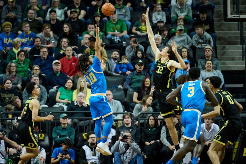 Feb 11, 2023; Eugene, Oregon, USA; UCLA Bruins guard Tyger Campbell (10) puts up shot during the first half against Oregon Ducks center Nate Bittle (32) at Matthew Knight Arena. Mandatory Credit: Troy Wayrynen-USA TODAY Sports