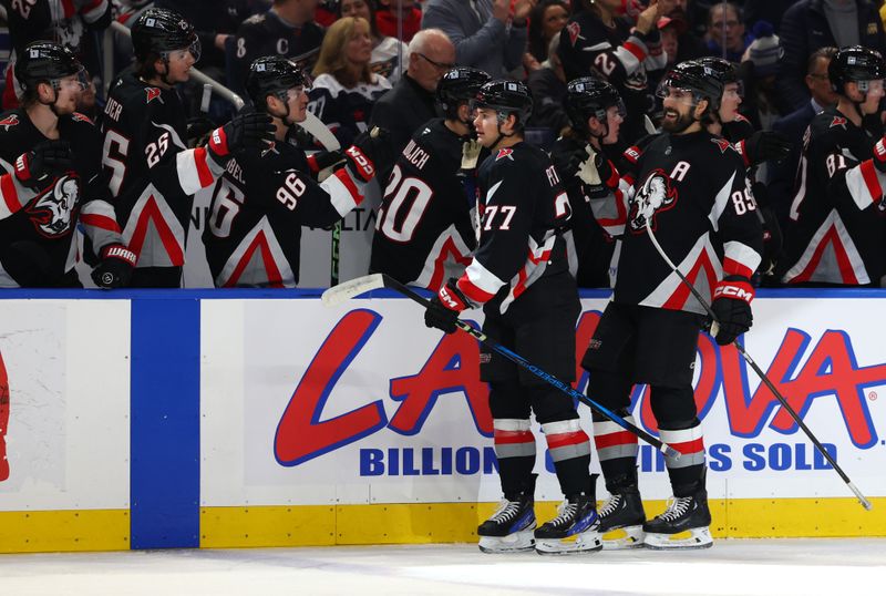 Jan 6, 2025; Buffalo, New York, USA;  Buffalo Sabres right wing JJ Peterka (77) celebrates his goal with teammates during the first period against the Washington Capitals at KeyBank Center. Mandatory Credit: Timothy T. Ludwig-Imagn Images