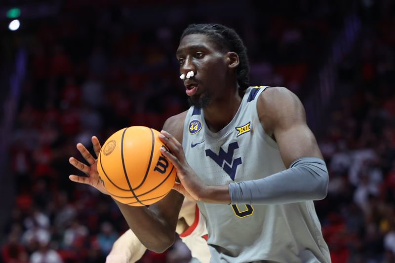 Mar 4, 2025; Salt Lake City, Utah, USA; West Virginia Mountaineers center Eduardo Andre passes the ball against the Utah Utes during the first half at Jon M. Huntsman Center. Mandatory Credit: Rob Gray-Imagn Images