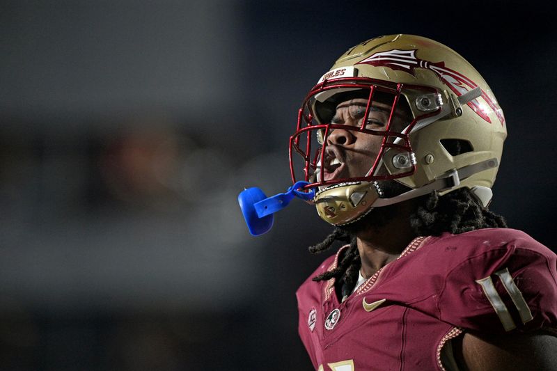 Oct 21, 2023; Tallahassee, Florida, USA; Florida State Seminoles defensive lineman Patrick Payton (11) celebrates a stop during the second half against the Duke Blue Devils at Doak S. Campbell Stadium. Mandatory Credit: Melina Myers-USA TODAY Sports