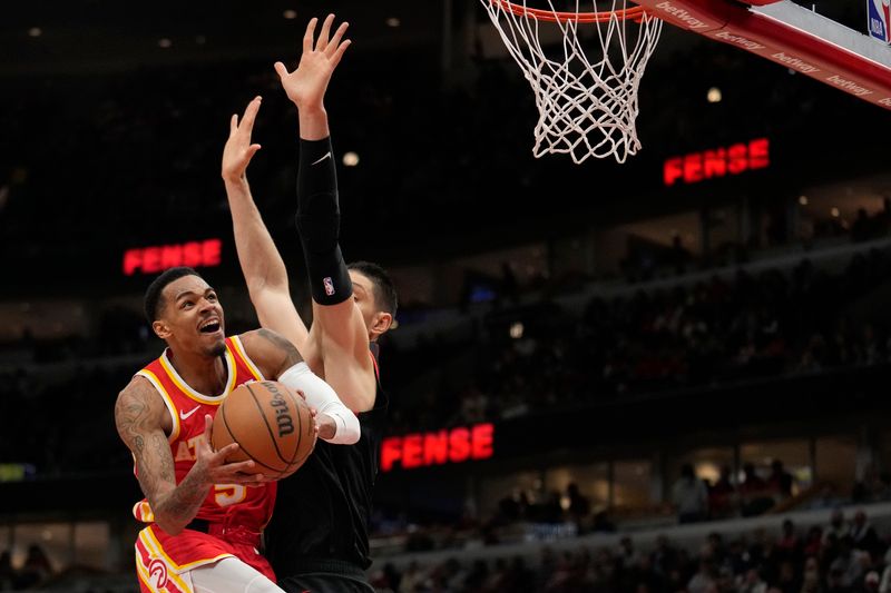 CHICAGO, ILLINOIS - APRIL 01: Dejounte Murray #5 of the Atlanta Hawks goes to the basket against Nikola Vucevic #9 of the Chicago Bulls during the first half at the United Center on April 01, 2024 in Chicago, Illinois. NOTE TO USER: User expressly acknowledges and agrees that, by downloading and or using this photograph, User is consenting to the terms and conditions of the Getty Images License Agreement. (Photo by Patrick McDermott/Getty Images)