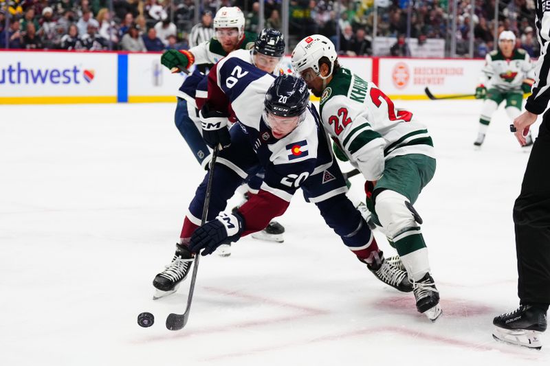 Feb 28, 2025; Denver, Colorado, USA; Minnesota Wild center Marat Khusnutdinov (22) defends on Colorado Avalanche center Ross Colton (20) in the first period at Ball Arena. Mandatory Credit: Ron Chenoy-Imagn Images