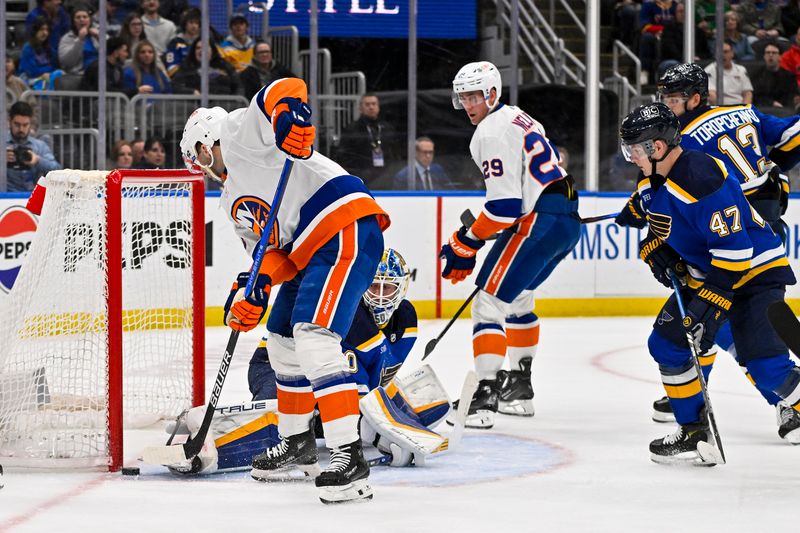 Feb 22, 2024; St. Louis, Missouri, USA;  St. Louis Blues goaltender Jordan Binnington (50) defends the net against New York Islanders center Kyle Palmieri (21) during the first period at Enterprise Center. Mandatory Credit: Jeff Curry-USA TODAY Sports