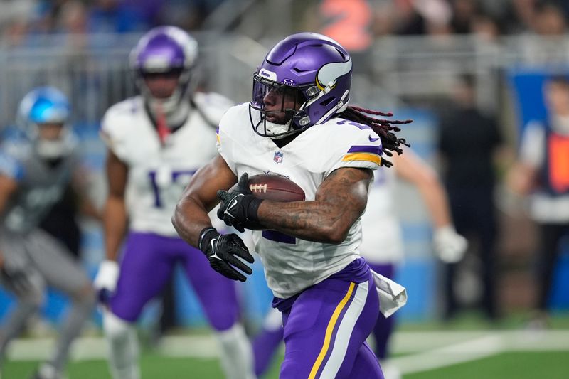 Minnesota Vikings running back Alexander Mattison (2) runs the ball against the Detroit Lions in the first half of an NFL football game in Detroit, Sunday, Jan. 7, 2024. (AP Photo/Paul Sancya)