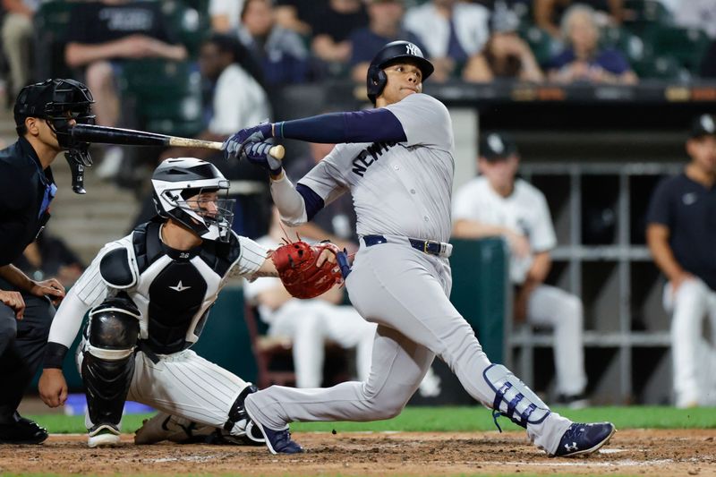 Aug 13, 2024; Chicago, Illinois, USA; New York Yankees outfielder Juan Soto (22) hits a solo home run against the Chicago White Sox during the seventh inning at Guaranteed Rate Field. Mandatory Credit: Kamil Krzaczynski-USA TODAY Sports