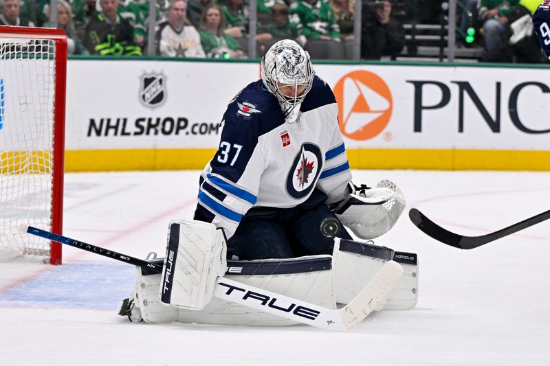 May 13, 2025; Dallas, Texas, USA; Winnipeg Jets goaltender Connor Hellebuyck (37) makes a pad save on a shot by Dallas Stars right wing Mikko Rantanen (96) during the second period in game four of the second round of the 2025 Stanley Cup Playoffs at American Airlines Center. Mandatory Credit: Jerome Miron-Imagn Images