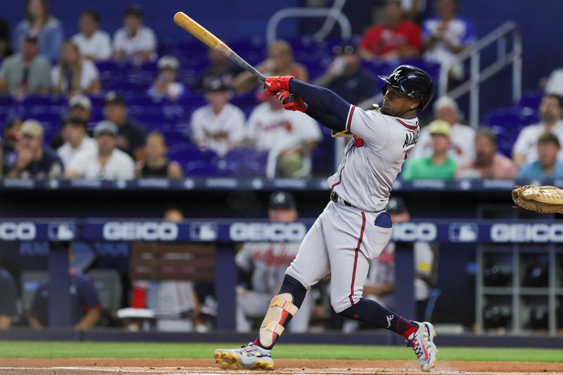 Sep 16, 2023; Miami, Florida, USA; Atlanta Braves second baseman Ozzie Albies (1) hits a two-run home run against the Miami Marlins during the first inning at loanDepot Park. Mandatory Credit: Sam Navarro-USA TODAY Sports