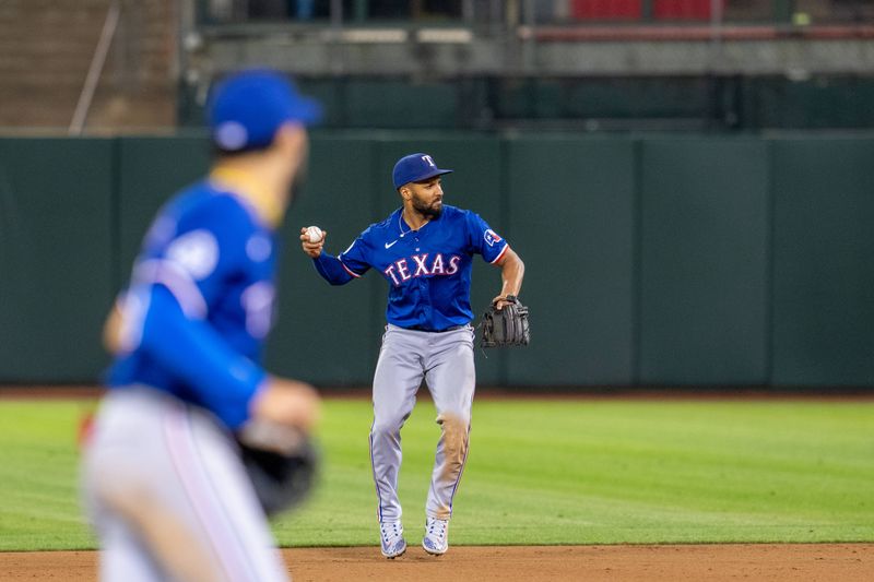 Sep 24, 2024; Oakland, California, USA; Texas Rangers second baseman Marcus Semien (2) throws out Oakland Athletics first baseman Tyler Soderstrom (not pictured) during the eighth inning at Oakland-Alameda County Coliseum. Mandatory Credit: Neville E. Guard-Imagn Images