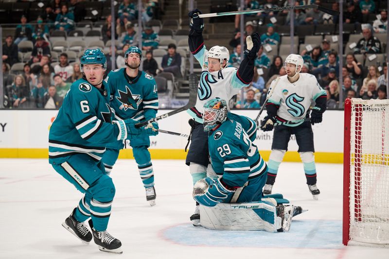 Jan 30, 2024; San Jose, California, USA; Seattle Kraken center Yanni Gourde (37) reacts in the goal crease against San Jose Sharks goaltender Mackenzie Blackwood (29) and defenseman Ty Emberson (6) during the third period at SAP Center at San Jose. Mandatory Credit: Robert Edwards-USA TODAY Sports