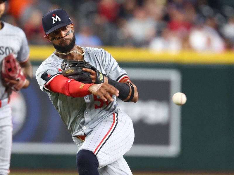 Jun 25, 2024; Phoenix, Arizona, USA; Minnesota Twins shortstop Willi Castro fields a ground ball in the seventh inning against the Arizona Diamondbacks at Chase Field. Mandatory Credit: Mark J. Rebilas-USA TODAY Sports