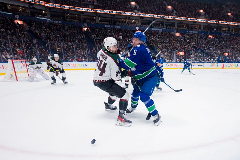 Jan 18, 2024; Vancouver, British Columbia, CAN; Arizona Coyotes defenseman Matt Dumba (24) battles with Vancouver Canucks forward Brock Boeser (6) in the third period at Rogers Arena. Vancouver won 2-1. Mandatory Credit: Bob Frid-USA TODAY Sports