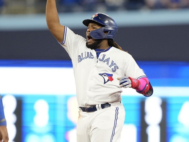 Sep 8, 2023; Toronto, Ontario, CAN; Toronto Blue Jays first baseman Vladimir Guerrero Jr. (27) celebrates his two RBI double against the Kansas City Royals during the seventh inning at Rogers Centre. Mandatory Credit: John E. Sokolowski-USA TODAY Sports