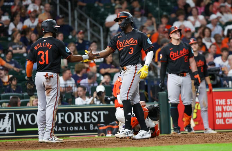 Jun 21, 2024; Houston, Texas, USA; Baltimore Orioles center fielder Cedric Mullins (31) celebrates second baseman Jorge Mateo (3) two run home run against the Houston Astros in the eighth inning at Minute Maid Park. Mandatory Credit: Thomas Shea-USA TODAY Sports