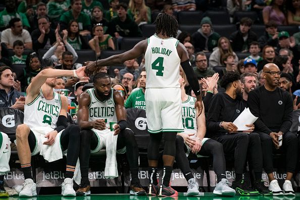 Boston, MA - December 17: Boston Celtics PG Jrue Holiday high fives teammates after departing the game in the fourth quarter. The Celtics beat the Orlando Magic, 114-97. (Photo by Tanner Pearson/The Boston Globe via Getty Images)