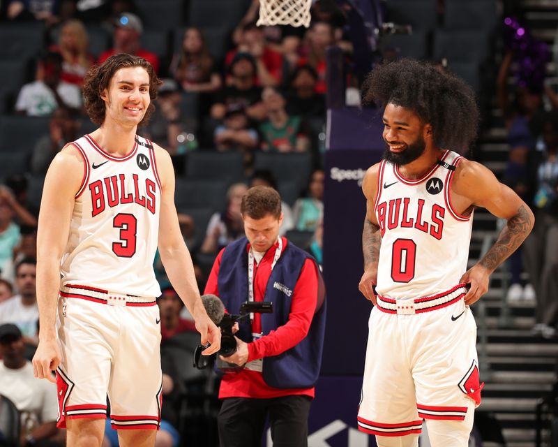 CHARLOTTE, NC - APRIL 6: Josh Giddey #3 and Coby White #0 of the Chicago Bulls smile before the game against the Charlotte Hornets on April 6, 2025 at Spectrum Center in Charlotte, North Carolina. NOTE TO USER: User expressly acknowledges and agrees that, by downloading and or using this photograph, User is consenting to the terms and conditions of the Getty Images License Agreement. Mandatory Copyright Notice: Copyright 2025 NBAE(Photo by Kent Smith/NBAE via Getty Images)