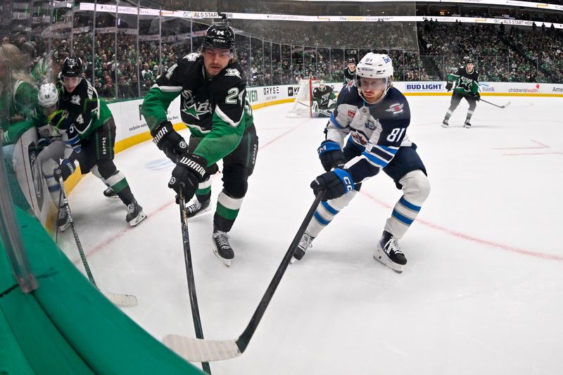 Feb 2, 2026; Dallas, Texas, USA; Dallas Stars center Roope Hintz (24) and Winnipeg Jets left wing Kyle Connor (81) battle for control of the puck during the third period at the American Airlines Center. Mandatory Credit: Jerome Miron-Imagn Images