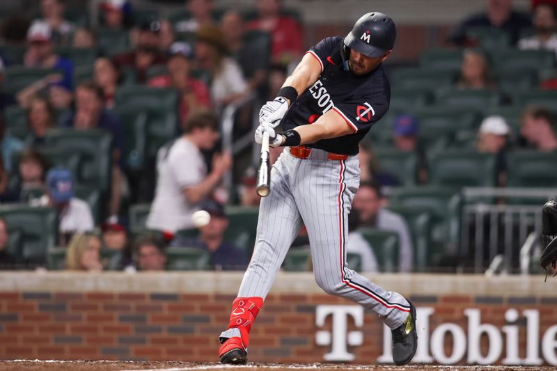 Apr 19, 2025; Atlanta, Georgia, USA; Minnesota Twins left fielder Trevor Larnach (9) hits a single against the Atlanta Braves in the sixth inning at Truist Park. Mandatory Credit: Brett Davis-Imagn Images