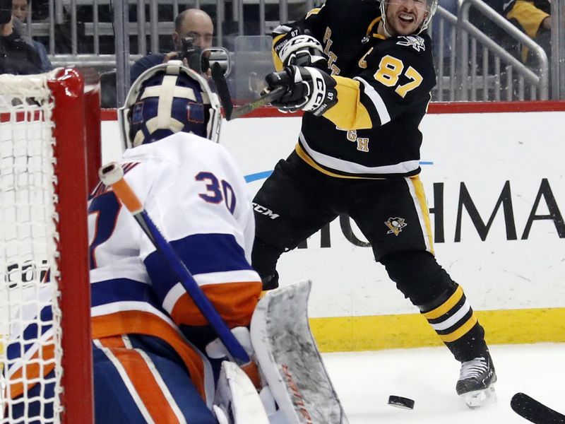 Mar 9, 2023; Pittsburgh, Pennsylvania, USA;  Pittsburgh Penguins center Sidney Crosby (87) shoots the puck against New York Islanders goaltender Ilya Sorokin (30) during the third period at PPG Paints Arena. The Islanders won 4-3 in overtime. Mandatory Credit: Charles LeClaire-USA TODAY Sports