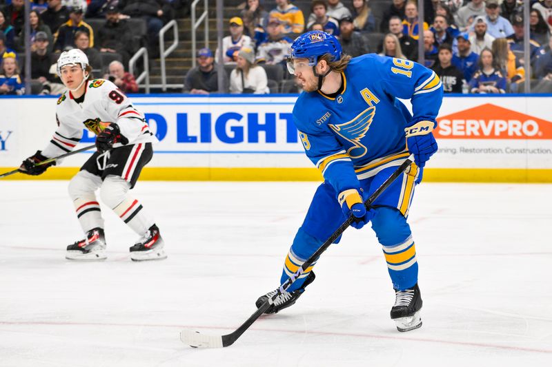 Mar 22, 2025; St. Louis, Missouri, USA;  St. Louis Blues center Robert Thomas (18) controls the puck against the Chicago Blackhawks during the first period at Enterprise Center. Mandatory Credit: Jeff Curry-Imagn Images
