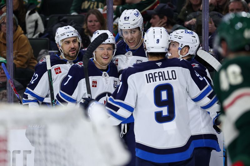 Jan 15, 2026; Saint Paul, Minnesota, USA; Winnipeg Jets defenseman Logan Stanley (64) celebrates his goal against the Minnesota Wild during the second period at Grand Casino Arena. Mandatory Credit: Matt Krohn-Imagn Images