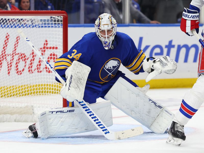 Oct 9, 2025; Buffalo, New York, USA;  Buffalo Sabres goaltender Alex Lyon (34) looks for the puck during the second period against the New York Rangers at KeyBank Center. Mandatory Credit: Timothy T. Ludwig-Imagn Images