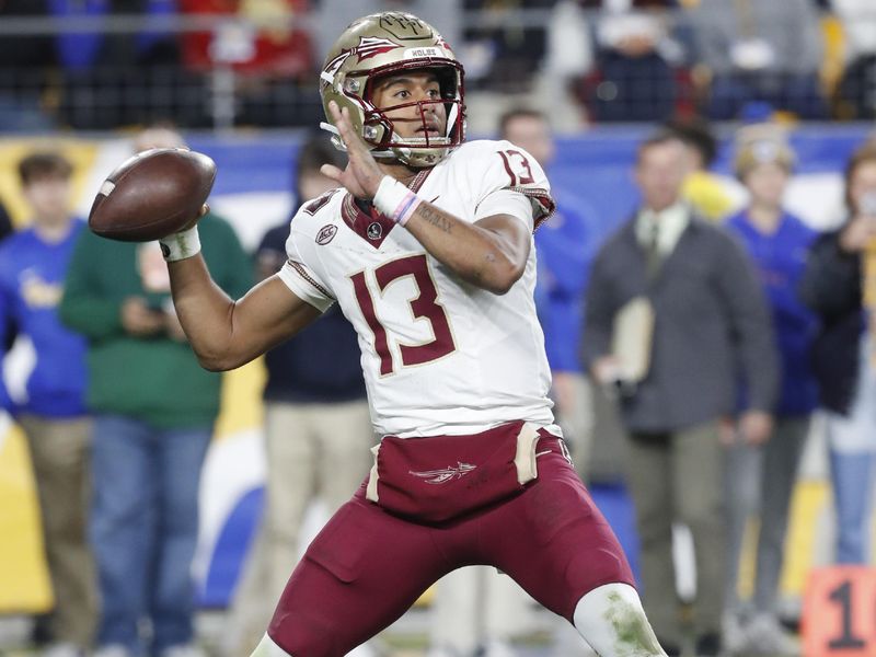 Nov 4, 2023; Pittsburgh, Pennsylvania, USA;  Florida State Seminoles quarterback Jordan Travis (13) passes the ball against the Pittsburgh Panthers during the third quarter at Acrisure Stadium. The Seminoles won 24-7. Mandatory Credit: Charles LeClaire-USA TODAY Sports