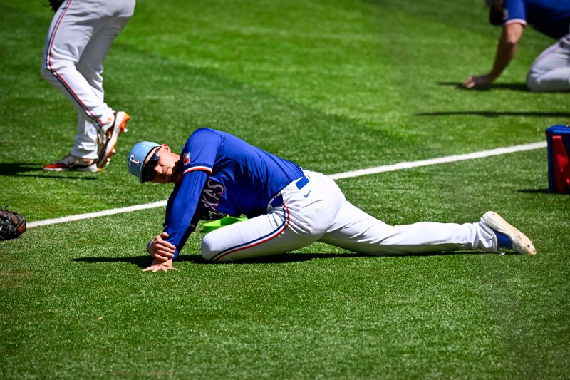 Mar 26, 2024; Arlington, Texas, USA; Texas Rangers shortstop Corey Seager (5) stretches before the game against the Boston Red Sox at Globe Life Field. Mandatory Credit: Jerome Miron-USA TODAY Sports