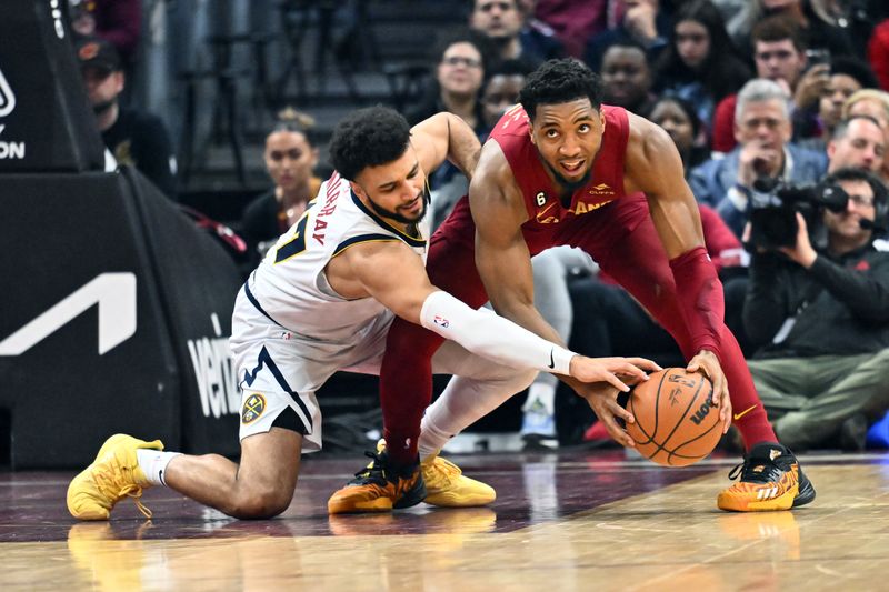 CLEVELAND, OHIO - FEBRUARY 23: Jamal Murray #27 of the Denver Nuggets tries for a steal from Donovan Mitchell #45 of the Cleveland Cavaliers during the second quarter at Rocket Mortgage Fieldhouse on February 23, 2023 in Cleveland, Ohio. NOTE TO USER: User expressly acknowledges and agrees that, by downloading and or using this photograph, User is consenting to the terms and conditions of the Getty Images License Agreement. (Photo by Jason Miller/Getty Images)