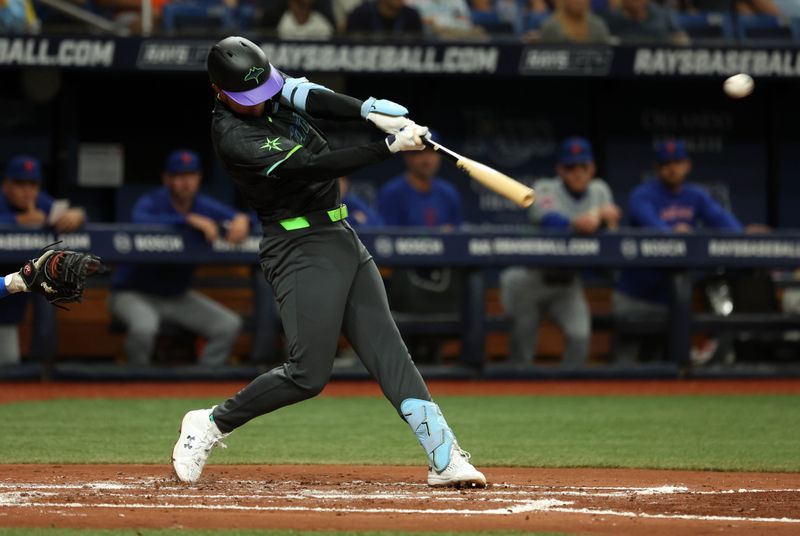 May 3, 2024; St. Petersburg, Florida, USA;  Tampa Bay Rays second base Curtis Mead (25) hits a RBI double against the New York Mets during the second inning at Tropicana Field. Mandatory Credit: Kim Klement Neitzel-USA TODAY Sports