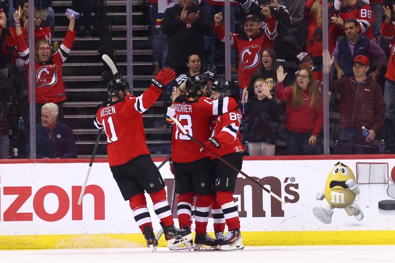 Oct 14, 2024; Newark, New Jersey, USA; New Jersey Devils center Nico Hischier (13) celebrates his goal against the Utah Hockey Club during the third period at Prudential Center. Mandatory Credit: Ed Mulholland-Imagn Images