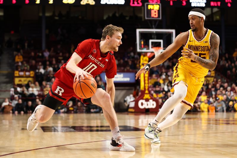 Mar 2, 2023; Minneapolis, Minnesota, USA; Rutgers Scarlet Knights guard Cam Spencer (10) dribbles while Minnesota Golden Gophers guard Ta'lon Cooper (55) defends during the second half at Williams Arena. Mandatory Credit: Matt Krohn-USA TODAY Sports