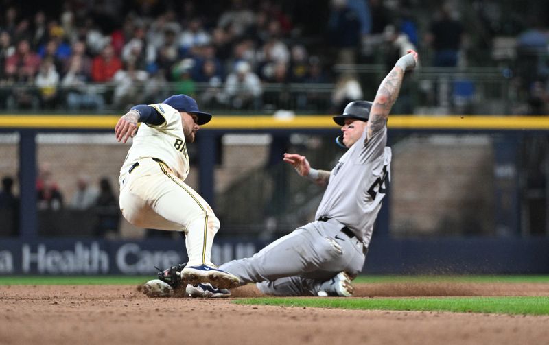 Apr 26, 2024; Milwaukee, Wisconsin, USA; Milwaukee Brewers second base Brice Turang (2) tags out Milwaukee Brewers catcher William Contreras (24) on an attempted steal in the ninth inning at American Family Field. Mandatory Credit: Michael McLoone-USA TODAY Sports