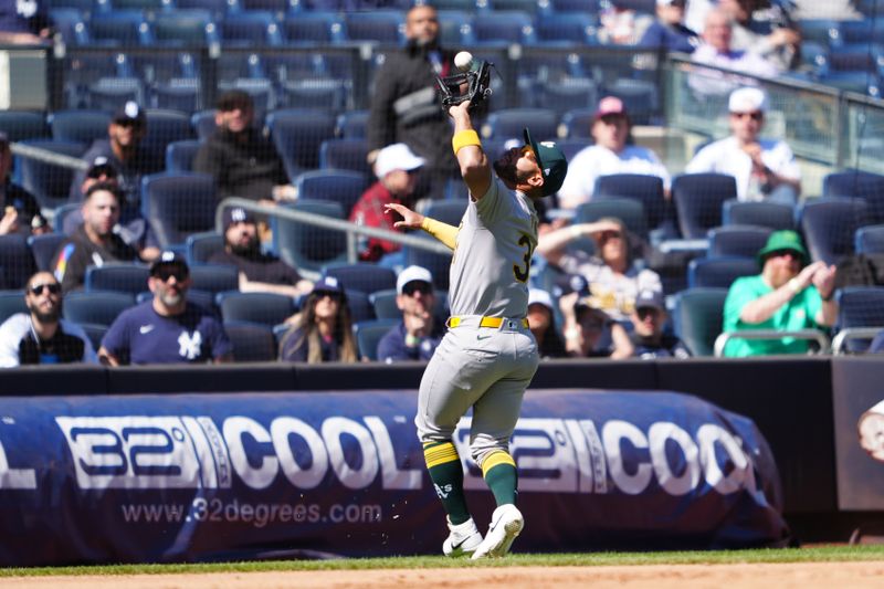 Apr 22, 2024; Bronx, New York, USA; Oakland Athletics third baseman Abraham Toro (31) catches a fly ball hit by New York Yankees first baseman Anthony Rizzo (not pictured) during the seventh inning at Yankee Stadium. Mandatory Credit: Gregory Fisher-USA TODAY Sports