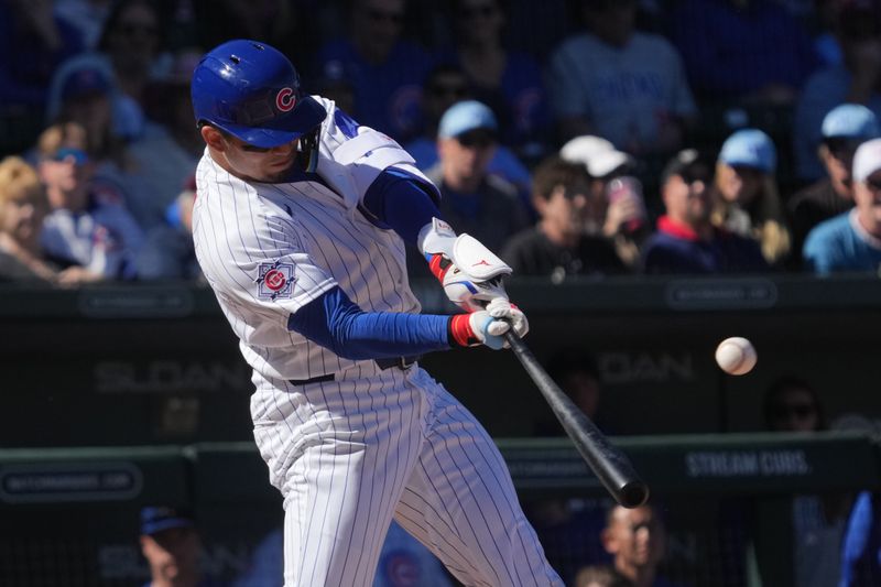 Feb 20, 2026; Mesa, Arizona, USA; Chicago Cubs right fielder Seiya Suzuki (27) hits a homerun against the Chicago White Sox in the first inning at Sloan Park. Mandatory Credit: Rick Scuteri-Imagn Images