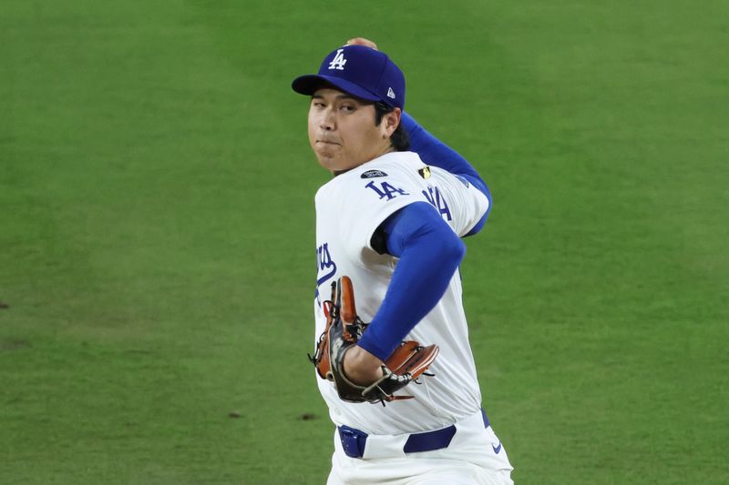 Oct 17, 2025; Los Angeles, California, USA; Los Angeles Dodgers two-way player Shohei Ohtani (17) throws against the Milwaukee Brewers during the third inning of game four of the NLCS round for the 2025 MLB playoffs at Dodger Stadium. Mandatory Credit: Kiyoshi Mio-Imagn Images