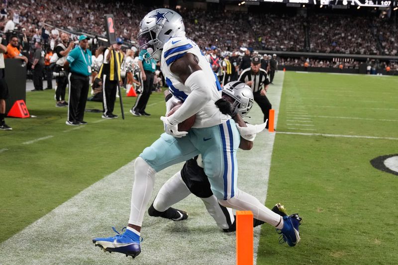 Dallas Cowboys wide receiver Ryan Flournoy, left, catches a pass for a touchdown against Las Vegas Raiders cornerback Jack Jones (18) during the first half of an NFL preseason football game, Saturday, Aug. 17, 2024, in Las Vegas. (AP Photo/Rick Scuteri)