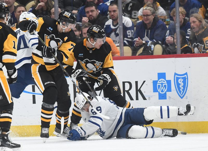 Nov 25, 2023; Pittsburgh, Pennsylvania, USA; Toronto Maple Leafs left wing Nicholas Robertson (89) is knocked from his skates at the feet of Pittsburgh Penguins center Evgeni Malkin (71) and defenseman John Ludvig (7) during the third period at PPG Paints Arena. Mandatory Credit: Philip G. Pavely-USA TODAY Sports