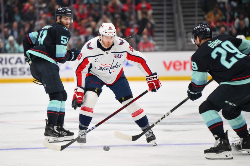 Jan 23, 2025; Seattle, Washington, USA; Washington Capitals right wing Taylor Raddysh (16) defends Seattle Kraken defenseman Vince Dunn (29) during the second period at Climate Pledge Arena. Mandatory Credit: Steven Bisig-Imagn Images