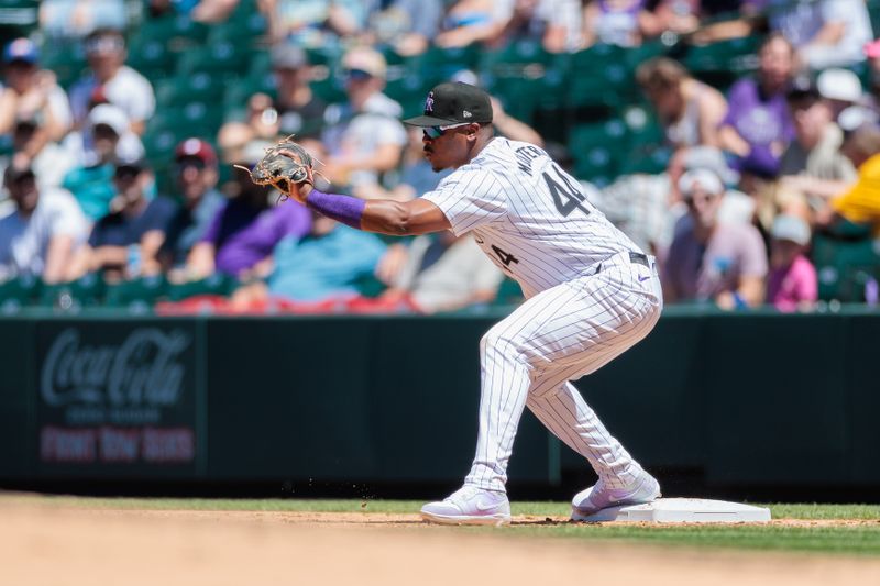 Jun 5, 2024; Denver, Colorado, USA; Colorado Rockies first base Elehuris Montero (44) catches a ball for an out during the fourth inning against the Cincinnati Reds at Coors Field. Mandatory Credit: Andrew Wevers-USA TODAY Sports