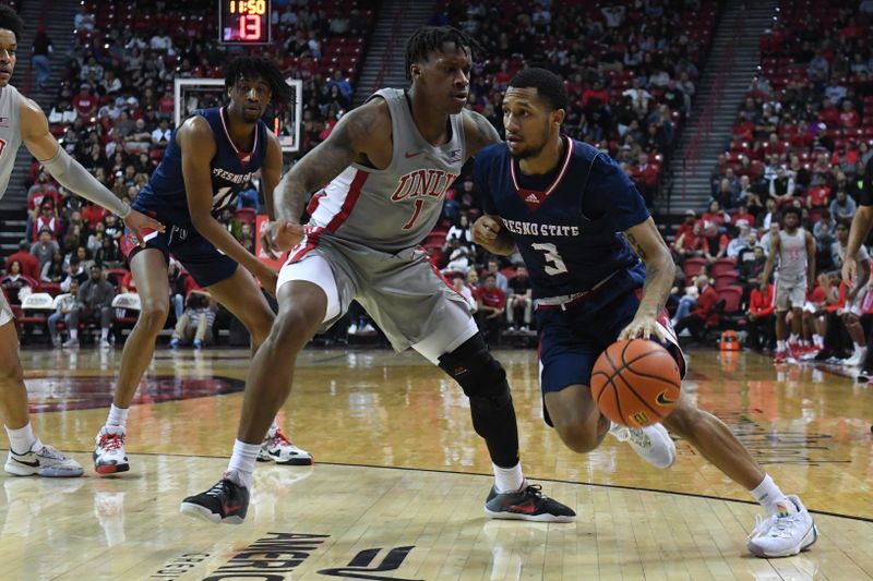 Feb 3, 2023; Las Vegas, Nevada, USA; UNLV Runnin' Rebels guard Elijah Parquet (1) defends against Fresno State Bulldogs guard Isaiah Hill (3) in the second half at Thomas & Mack Center. Mandatory Credit: Candice Ward-USA TODAY Sports