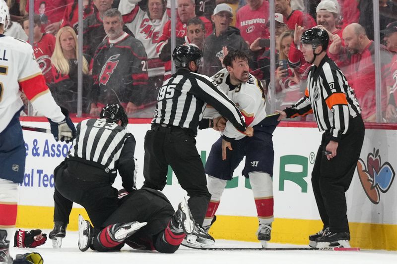 May 20, 2025; Raleigh, North Carolina, USA; Florida Panthers forward Brad Marchand (63) fights Carolina Hurricanes defenseman Shayne Gostibehere (4) during the third period in game one of the Eastern Conference Final of the 2025 Stanley Cup Playoffs at Lenovo Center. Mandatory Credit: James Guillory-Imagn Images