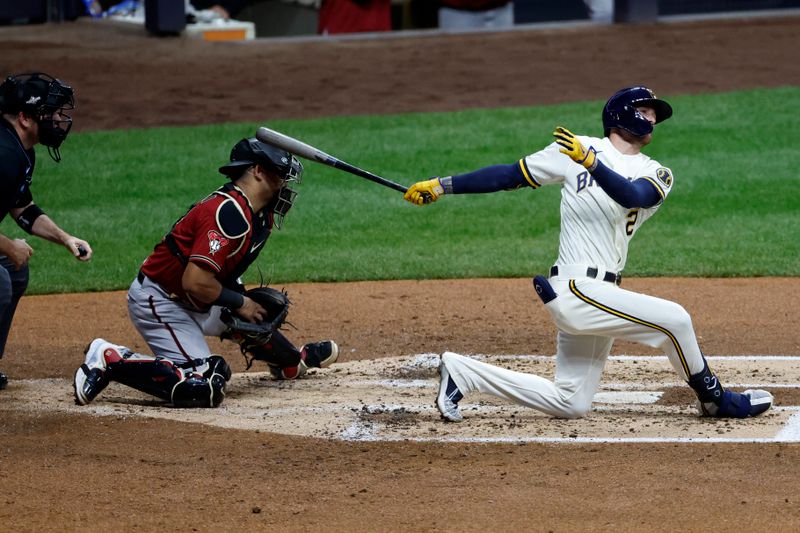 Oct 4, 2023; Milwaukee, Wisconsin, USA; Arizona Diamondbacks catcher Gabriel Moreno (14) is hit on a backswing by Milwaukee Brewers second baseman Brice Turang (2) in the second inning during game two of the Wildcard series for the 2023 MLB playoffs at American Family Field. Mandatory Credit: Kamil Krzaczynski-USA TODAY Sports