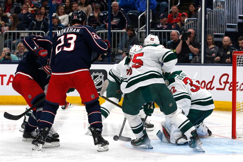 Oct 19, 2024; Columbus, Ohio, USA; Columbus Blue Jackets center Sean Monahan (23) looks for a rebound of a Minnesota Wild goalie Filip Gustavsson (32) dave during the second period  at Nationwide Arena. Mandatory Credit: Russell LaBounty-Imagn Images