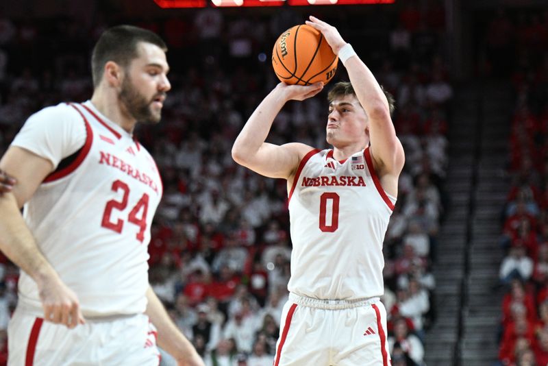 Mar 1, 2025; Lincoln, Nebraska, USA;  Nebraska Cornhuskers guard Connor Essegian (0) attempts a three point shot against the Minnesota Golden Gophers during the first half at Pinnacle Bank Arena. Mandatory Credit: Steven Branscombe-Imagn Images
