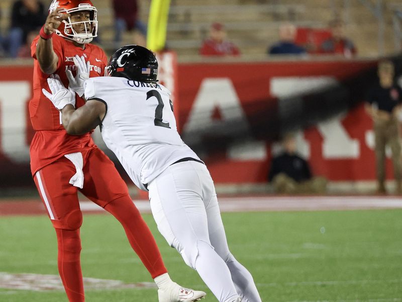 Nov 11, 2023; Houston, Texas, USA; Houston Cougars quarterback Donovan Smith (1) passes the all while being hit by Cincinnati Bearcats defensive lineman Dontay Corleone (2) in the second half at TDECU Stadium. Mandatory Credit: Thomas Shea-USA TODAY Sports