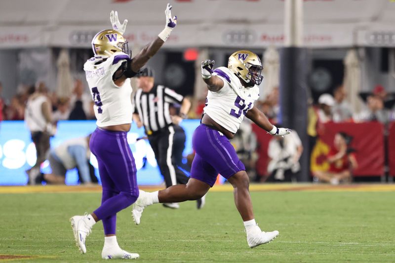 Nov 4, 2023; Los Angeles, California, USA; Washington Huskies defensive lineman Jayvon Parker (94) celebrates with defensive end Zion Tupuola-Fetui (4) after the Washington Huskies defeat the USC Trojans at United Airlines Field at Los Angeles Memorial Coliseum. Mandatory Credit: Jessica Alcheh-USA TODAY Sports